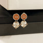 A bright, clean shot on a light grey or white background, showcasing the earrings' full shape and the sparkling contrast between metal and crystals. Alt text: "Miu Miu White Crystal and Metal Designer Earrings - Sparkling Statement Piece."