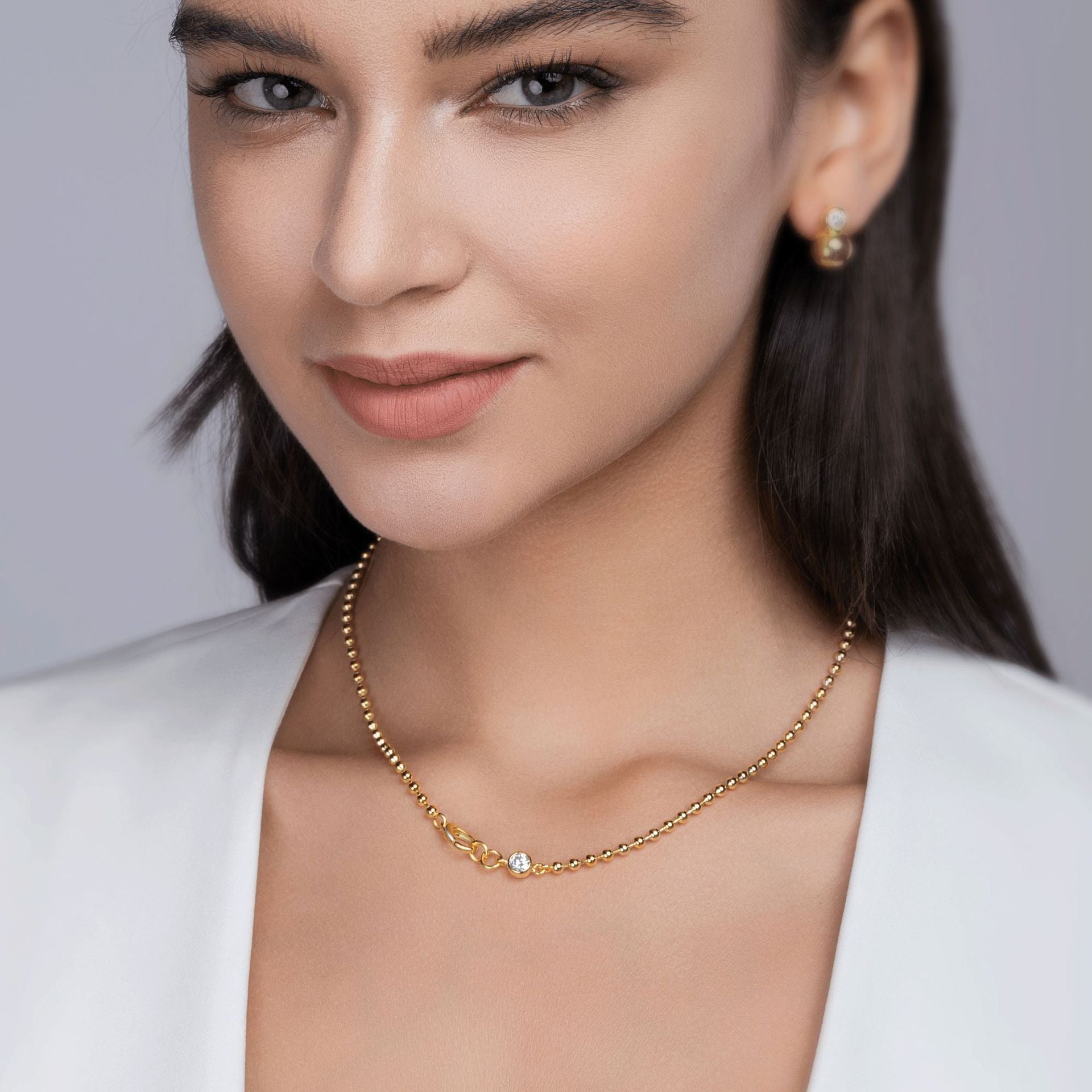 Model wearing the necklace alone on bare skin.