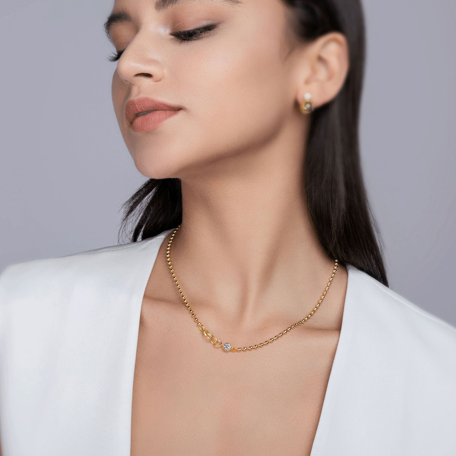 Model wearing the necklace alone on bare skin.