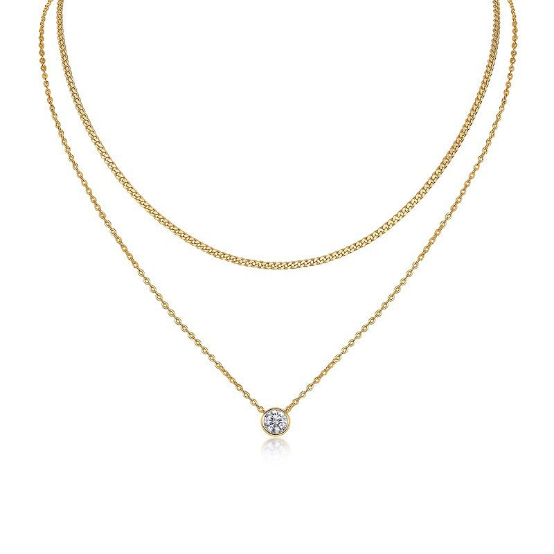 Clean white background — the bezel set moissanite solitaire on a fine chain layered with a chunky curb chain on a bust form. The smooth, modern bezel contrasts beautifully with the bold, textured curb links. Together, they create a balanced mix of delicate and edgy.