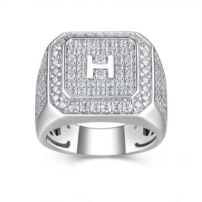 Silver ring with 'H' emblem on a white background
