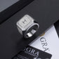 Silver ring with gemstones on a black and white background