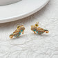  Earrings on seafoam background, showcasing seahorse with enamel and crystal eye. Alt: “New Kate Spade Seahorse Stud Earrings – Enamel Ocean Jewelry.”