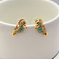  Earrings on seafoam background, showcasing seahorse with enamel and crystal eye. Alt: “New Kate Spade Seahorse Stud Earrings – Enamel Ocean Jewelry.”