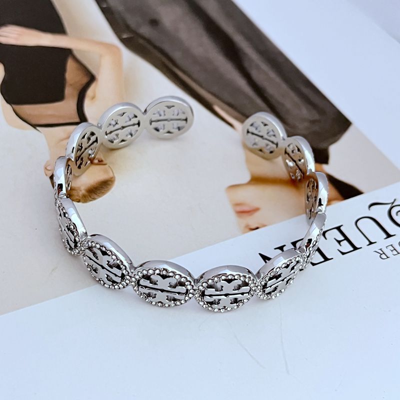 Cuff displayed on a dark, elegant surface with a subtle “NEW” badge or clean styling to emphasize its freshness.