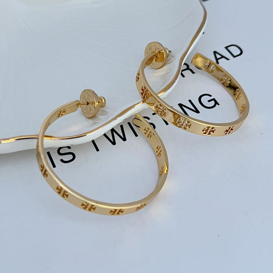 Both hoops displayed hanging against a clean, light background, clearly showing the cut-out T logo within the hoop structure.