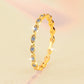 Gold ring with small diamonds on a gradient background