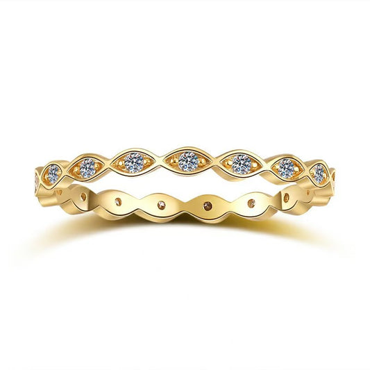 Gold ring with diamond accents on a white background