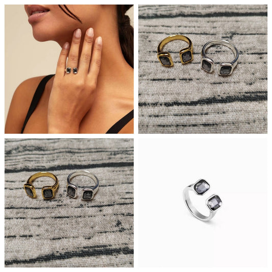 Open ring on neutral or dark background showing two gray crystals. Alt: “UNOde50 Open Ring with 2 Dark Gray Crystals.”