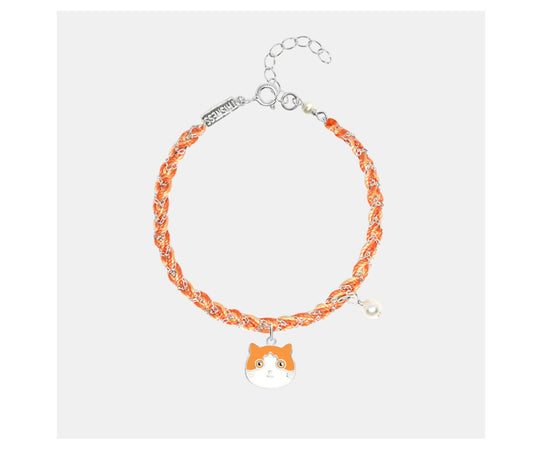 Bracelet with orange and white design on a light gray background
