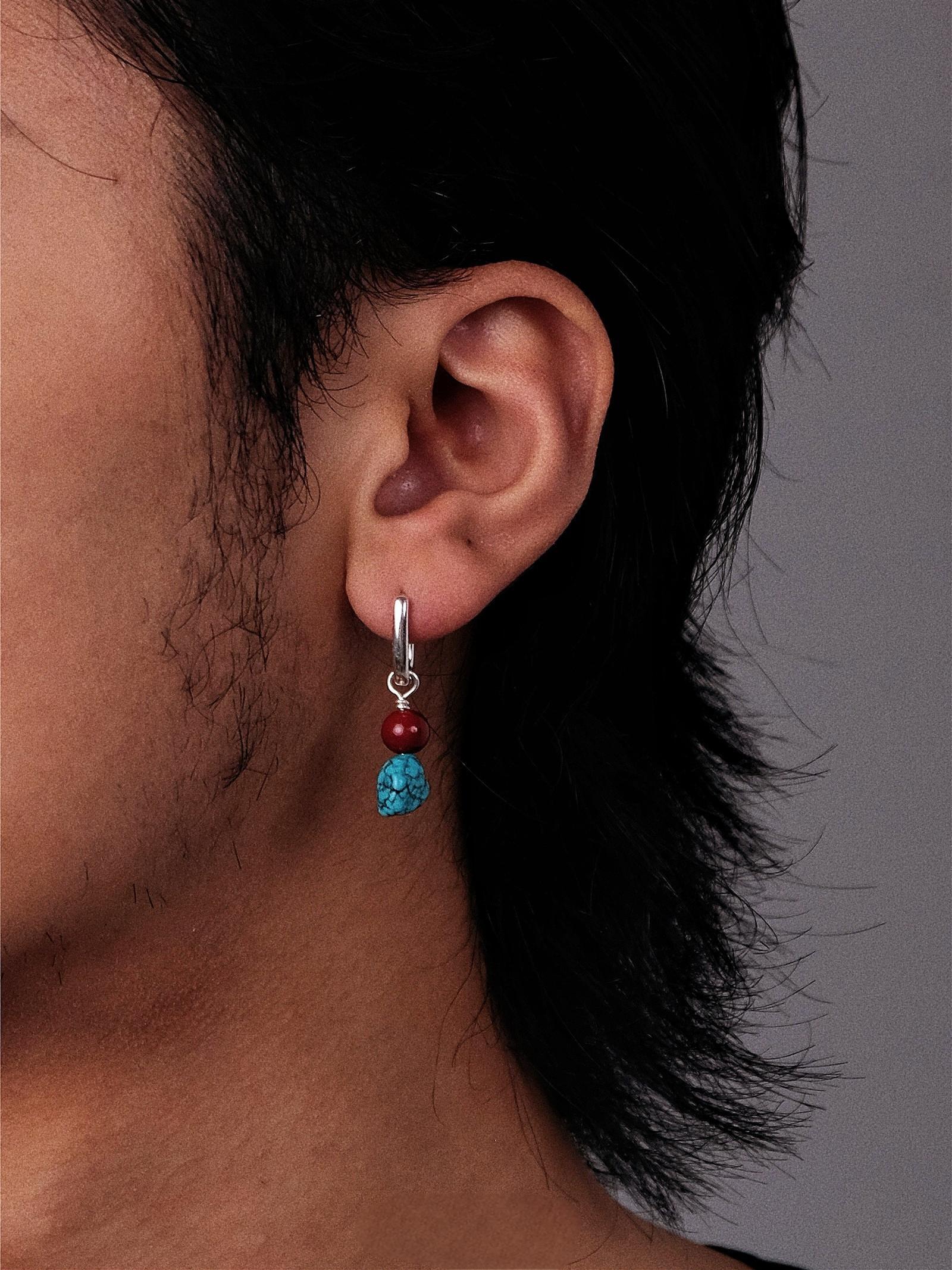 “Cultural artisan turquoise earrings worn by female model”