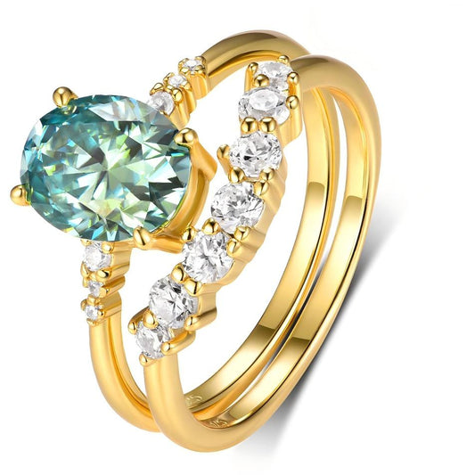 Yellow gold teal diamond stacking set on neutral background. Alt: “Oval Cut 2.0CT Blue Green Diamond Stacking Set – Yellow Gold.”