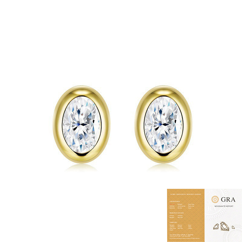 Gold oval moissanite studs on neutral background. Alt: “Oval Moissanite Bezel-Set Stud Earrings – 18K Gold.”
