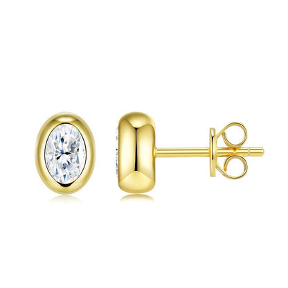 Gold oval moissanite studs on neutral background. Alt: “Oval Moissanite Bezel-Set Stud Earrings – 18K Gold.”