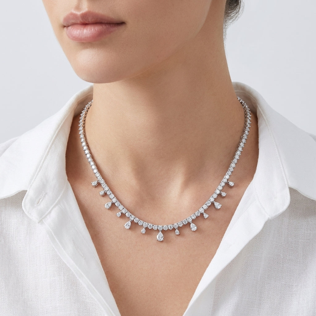 Diamond necklace worn by a person with a white shirt