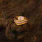 Yellow gold pear bridal set on neutral/romantic background. Alt: “Pear Moissanite Engagement Ring Set – 18K Yellow Gold.”