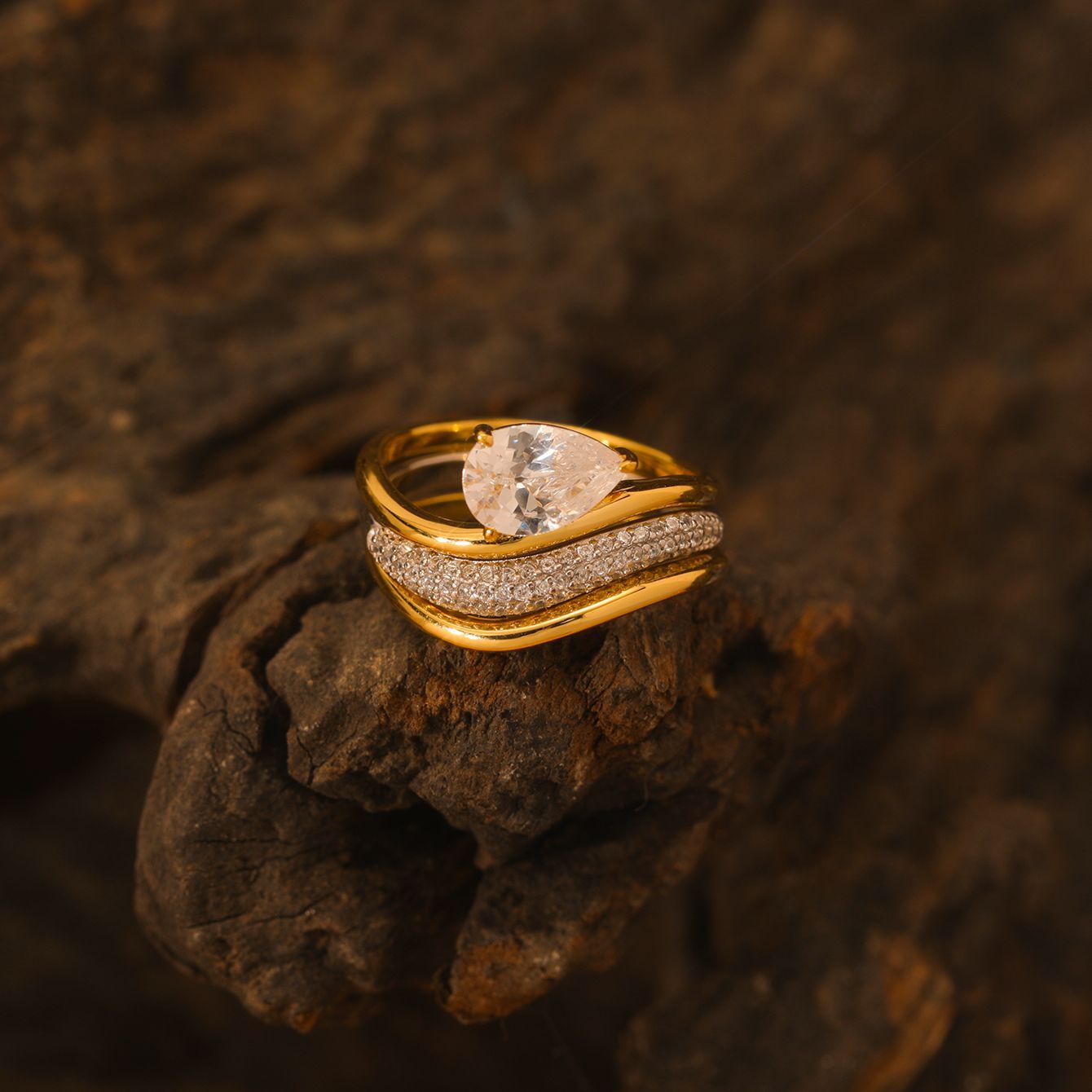 Yellow gold pear bridal set on neutral/romantic background. Alt: “Pear Moissanite Engagement Ring Set – 18K Yellow Gold.”