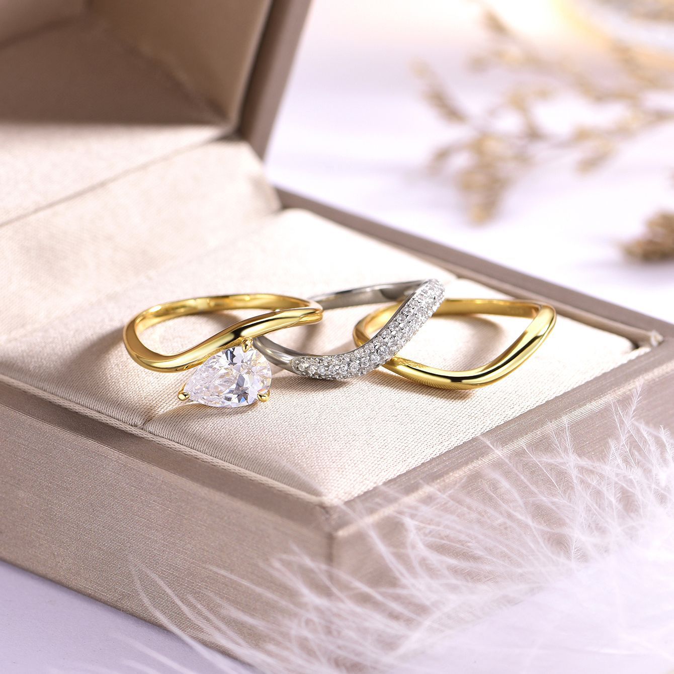 Yellow gold pear bridal set on neutral/romantic background. Alt: “Pear Moissanite Engagement Ring Set – 18K Yellow Gold.”