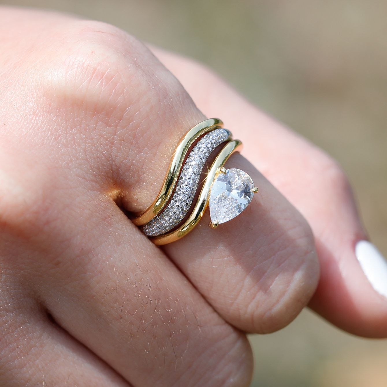 Yellow gold pear bridal set on neutral/romantic background. Alt: “Pear Moissanite Engagement Ring Set – 18K Yellow Gold.”