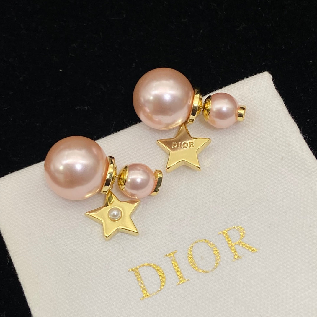 Pearl earrings Dior Gold in PearlPink pearl earrings with gold stars on a Dior branded pouch