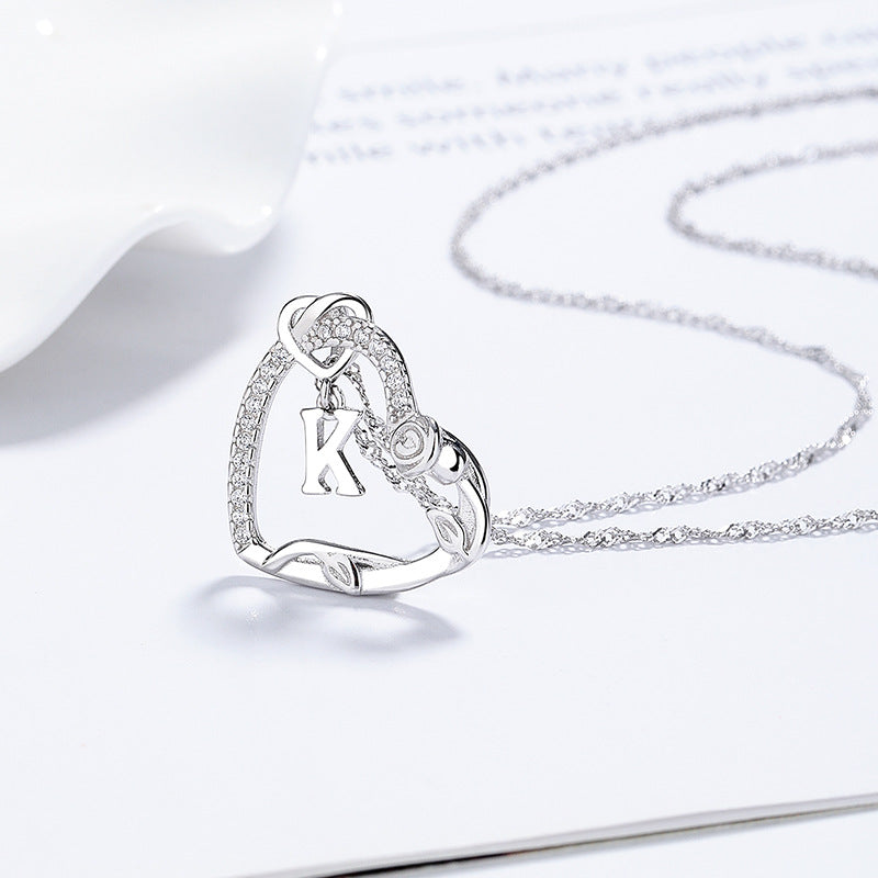  Heart pendant on soft blush or cream background. Alt: “Personalized Diamond-Encrusted Letter Heart Pendant – 18K Gold.”