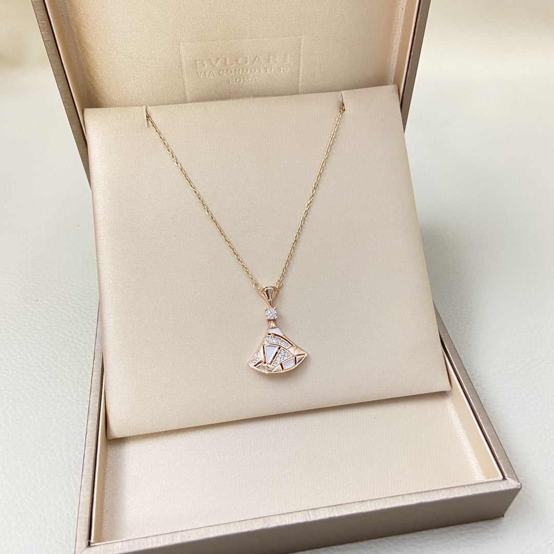 “Petal Grace” Natural Mother-of-Pearl Fan Pendant Necklace Gold panther-shaped ring with diamond detailing on a purple background