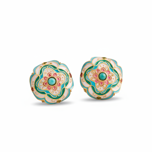 Pair of floral earrings with green and pink design on a white background