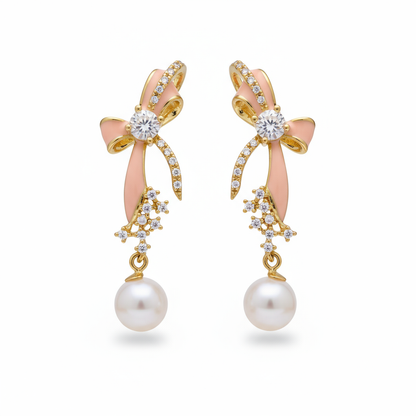 Pair of earrings with pink bows, gold accents, and pearl drops on a white background