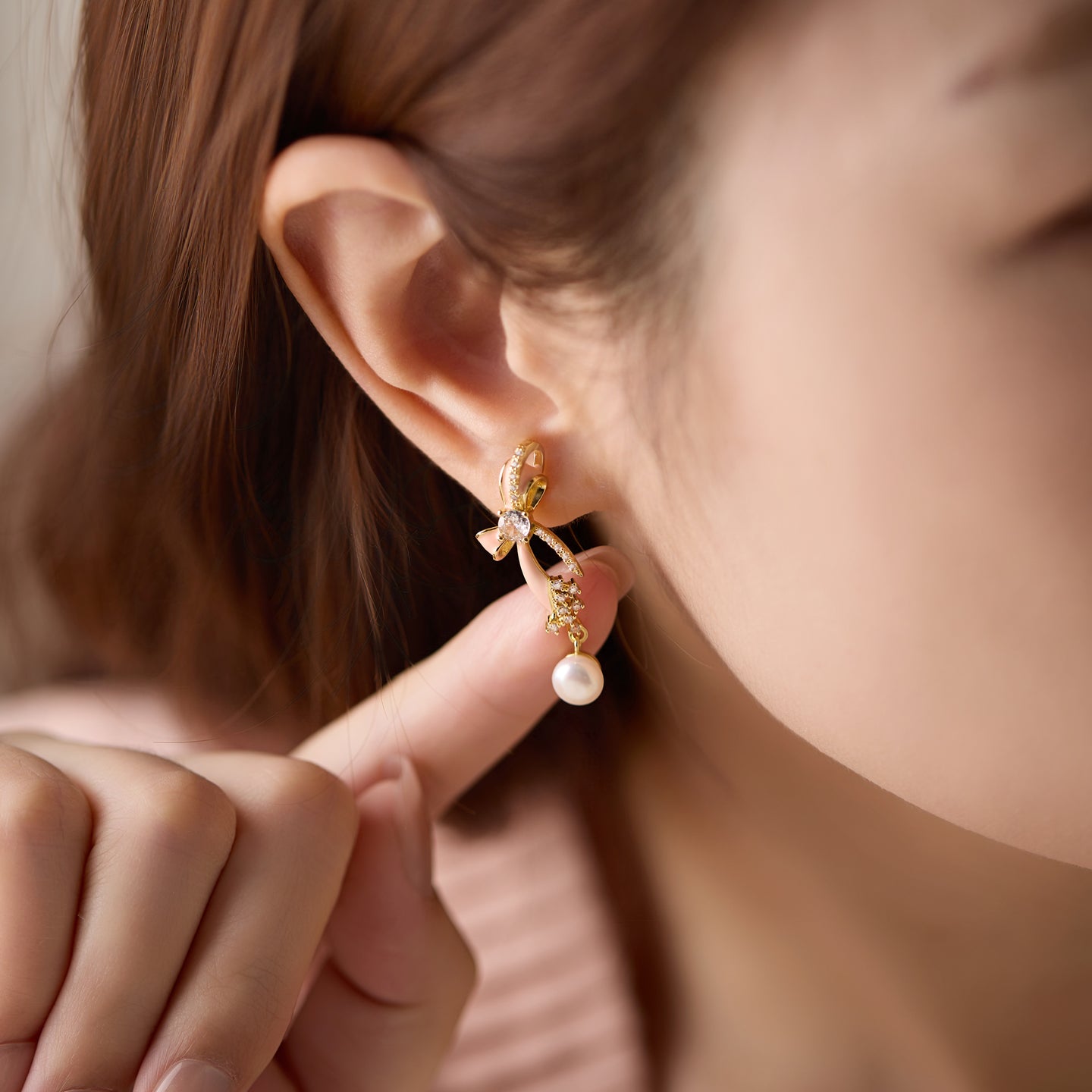 “Playful Charm Pearl Bow Earrings – minimalist sterling silver design for women”