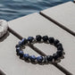 Bracelet with blue stones on a wooden surface near water