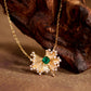 Gold necklace with a green gemstone pendant on a wooden surface