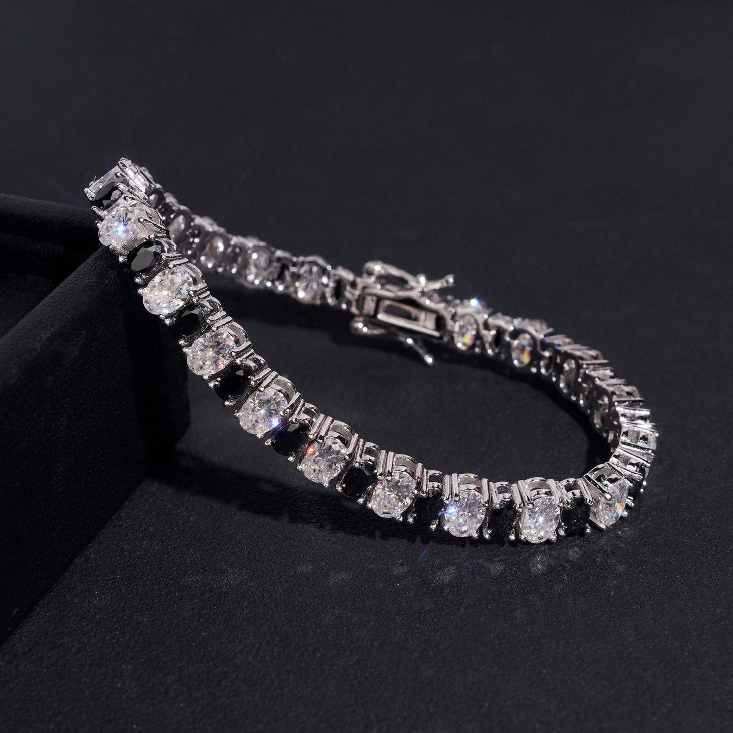 Straight-on to clearly showcase the alternating white and black round moissanite stones in continuous pave.