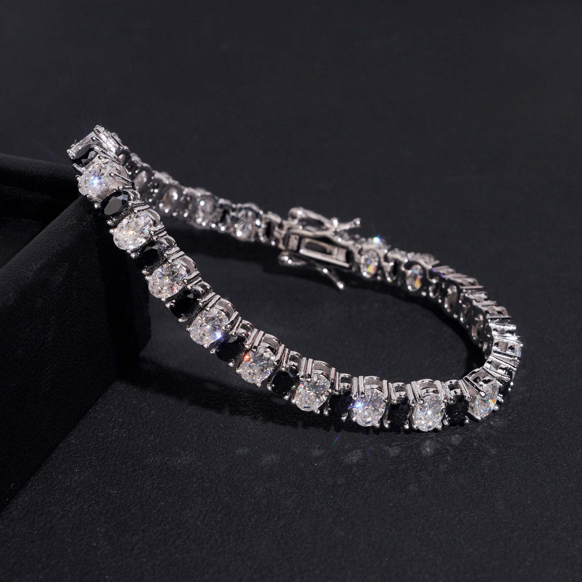 Straight-on to clearly showcase the alternating white and black round moissanite stones in continuous pave.