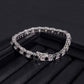 Straight-on to clearly showcase the alternating white and black round moissanite stones in continuous pave.