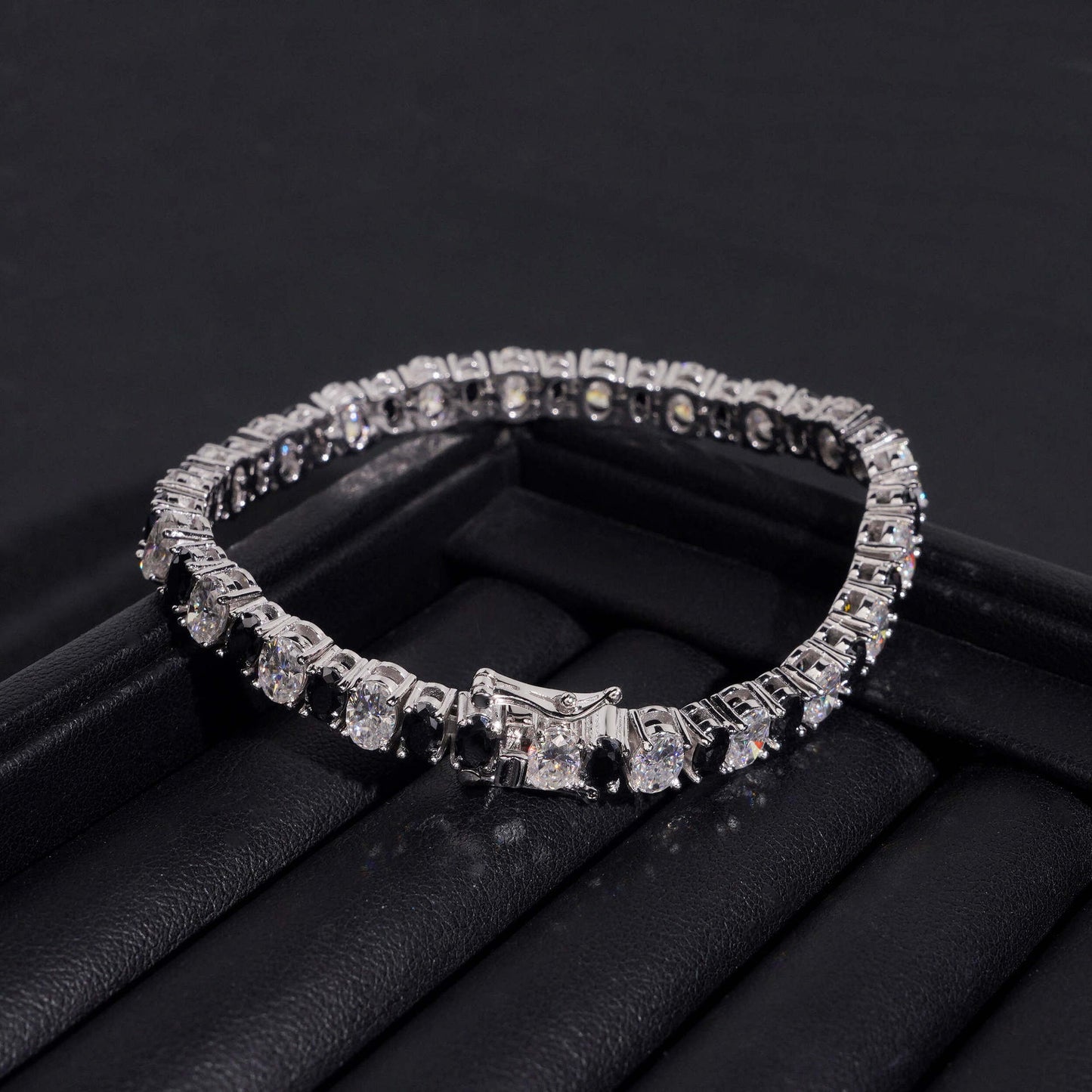 Straight-on to clearly showcase the alternating white and black round moissanite stones in continuous pave.