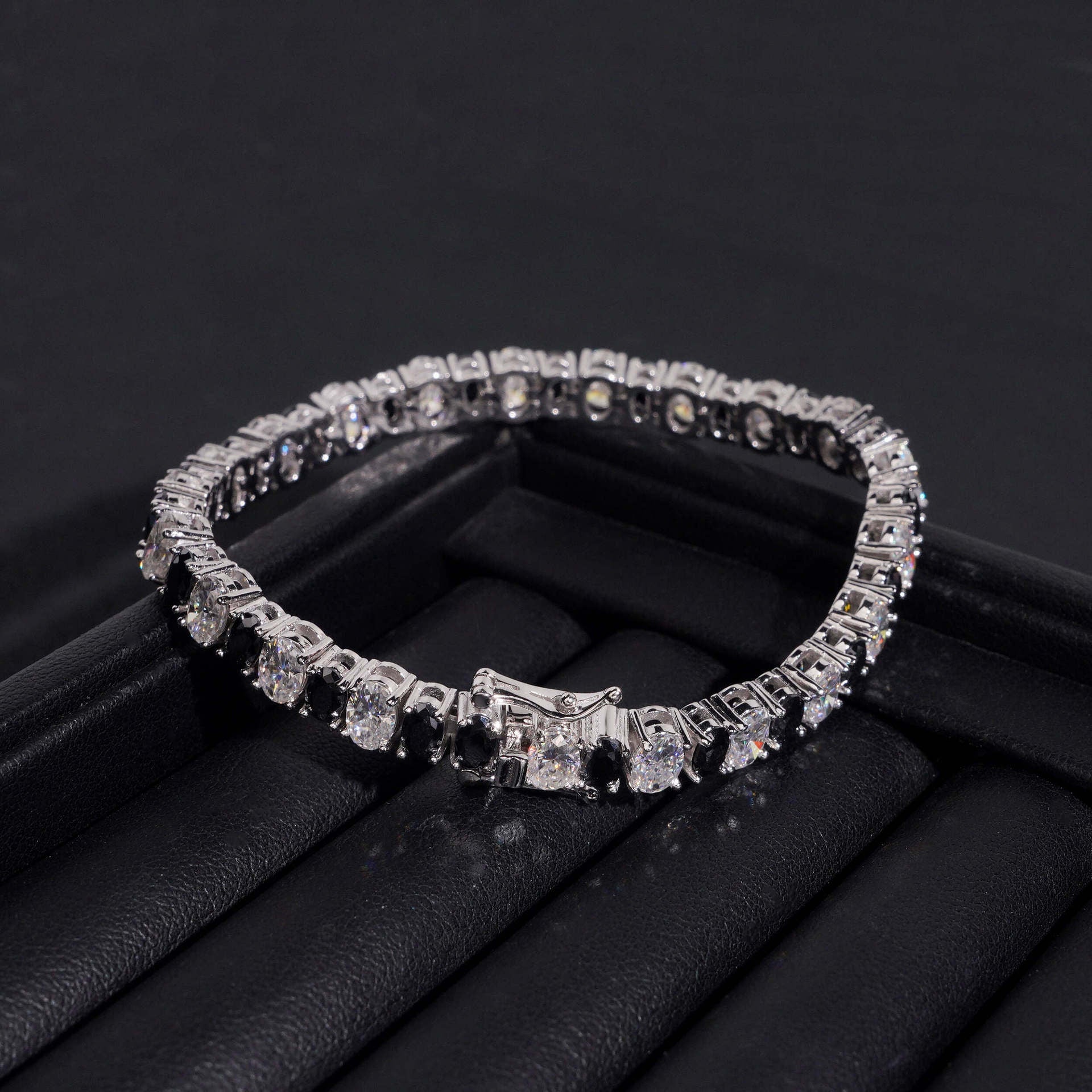 Straight-on to clearly showcase the alternating white and black round moissanite stones in continuous pave.