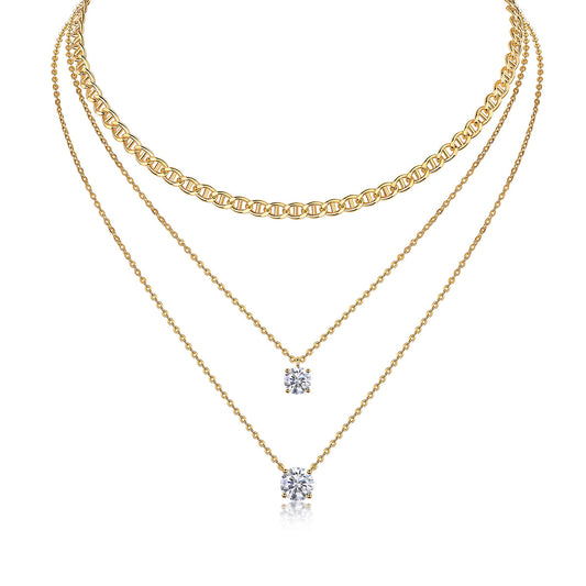 Clean white background — the round moissanite solitaire pendant layered with 2-3 mixed chains on a bust form. The round brilliant cut catches light from every angle, showcasing signature sparkle and fire. Chains vary in texture for balanced visual interest.