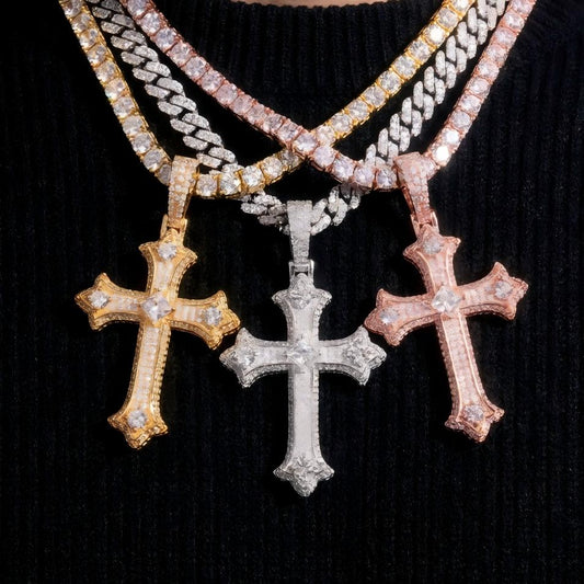 Three cross pendants on a chain against a black background