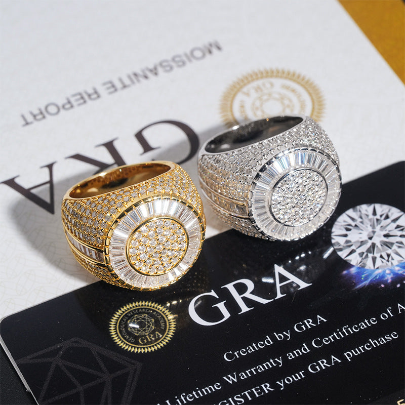 Two large statement ring bombers in yellow gold and silver, both heavily paved with clear stones, displayed on top of GRA branded cards.