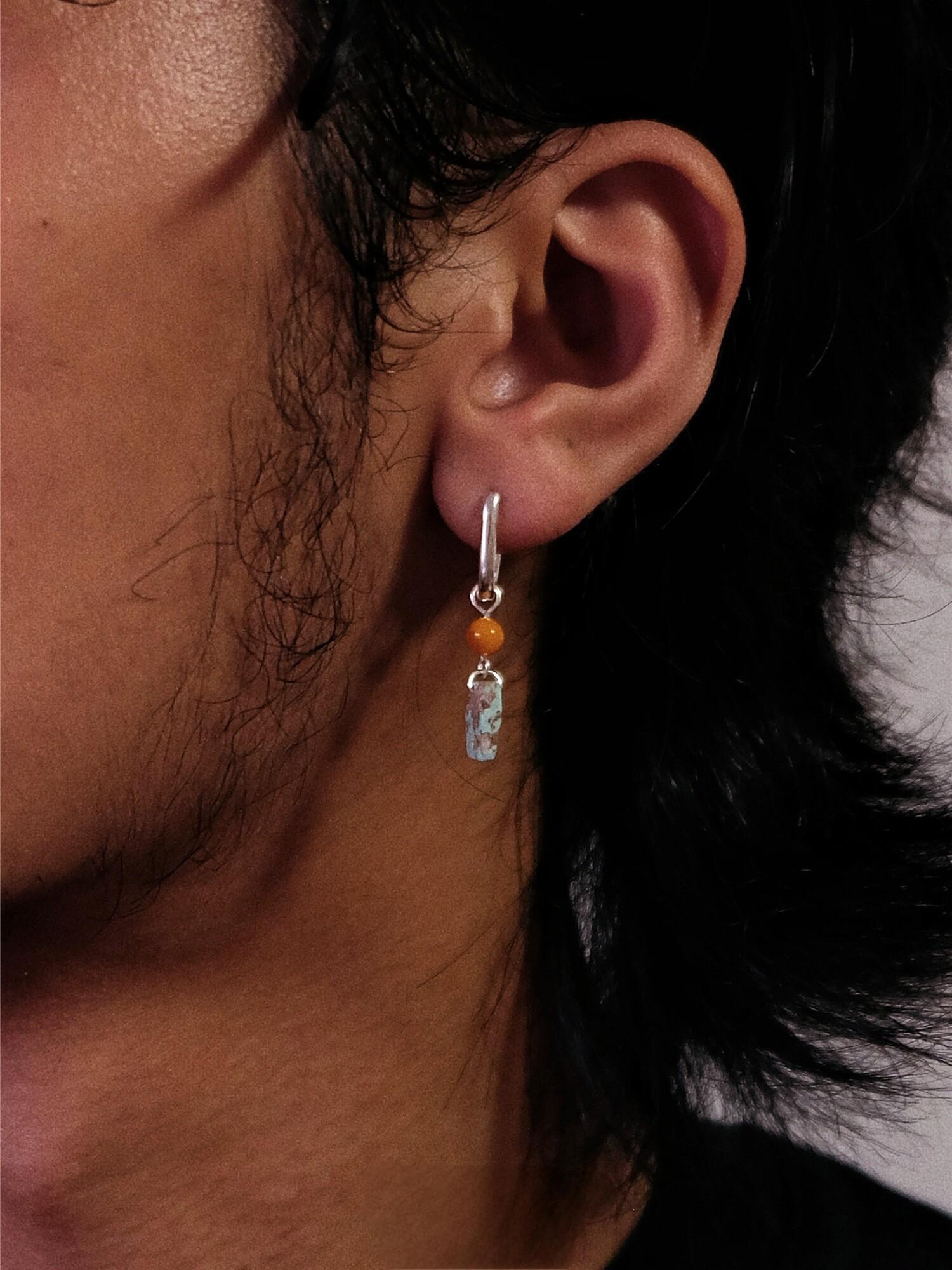 “Close-up of natural amber and turquoise set in sterling silver”