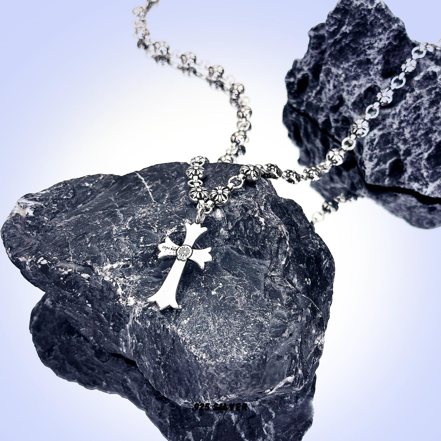 “Close-up of beaded sterling silver cross with dimensional texture”