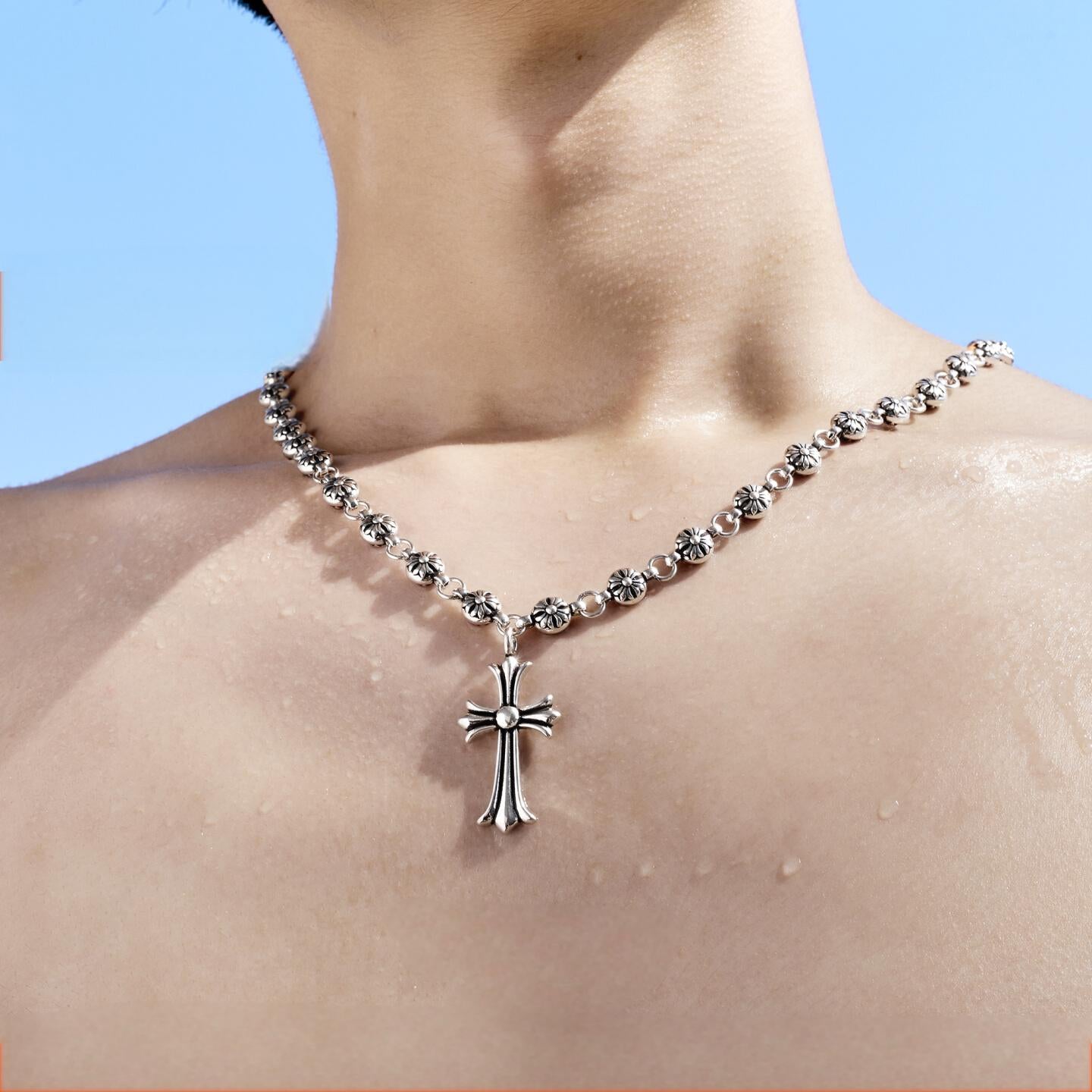 “Flat lay of S925 beaded silver cross necklace for men”