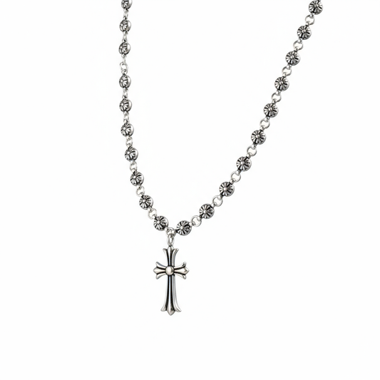 Silver rosary necklace with a cross pendant on a white background