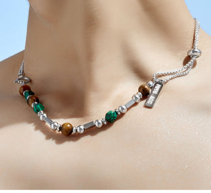 “Male model wearing modern oriental style silver beaded necklace”