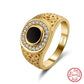 “Turkish black onyx men’s ring flat lay on textured surface”Gold ring with black center and diamonds on a white background