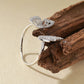 “Flat lay of S925 sterling silver butterfly ring with micro pave CZ stones”