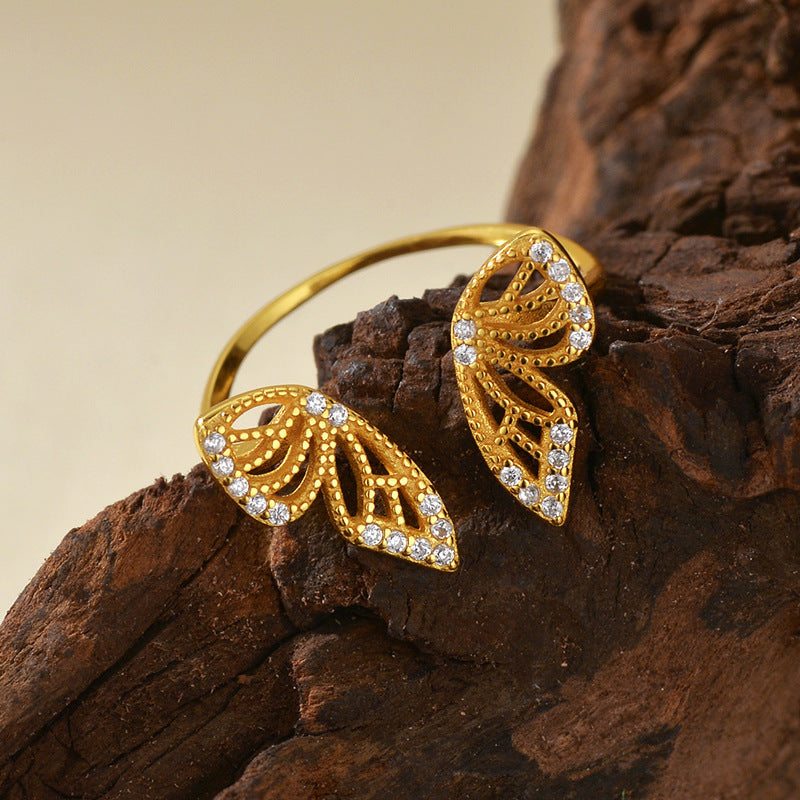 “Close-up of butterfly wings micro-paved with sparkling cubic zirconia on silver ring”
