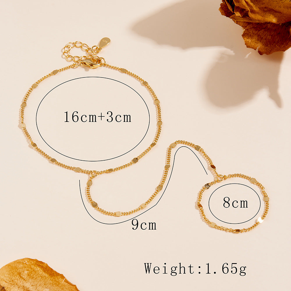 Gold bracelet with measurements and weight details on a beige background