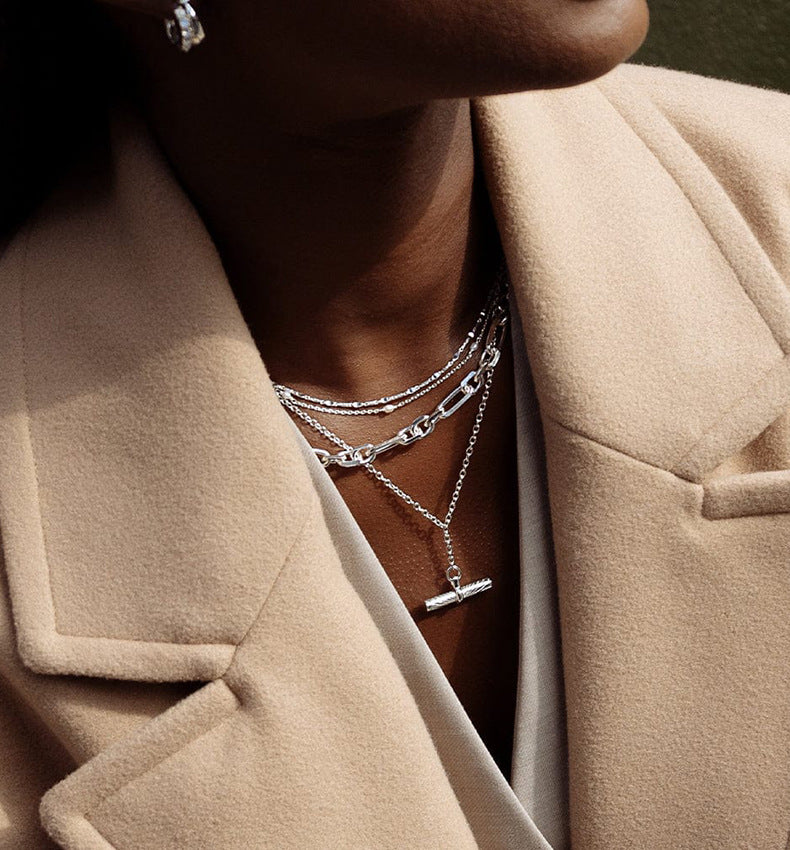 Woman Wearing Minimalist Cylinder Silver Necklace