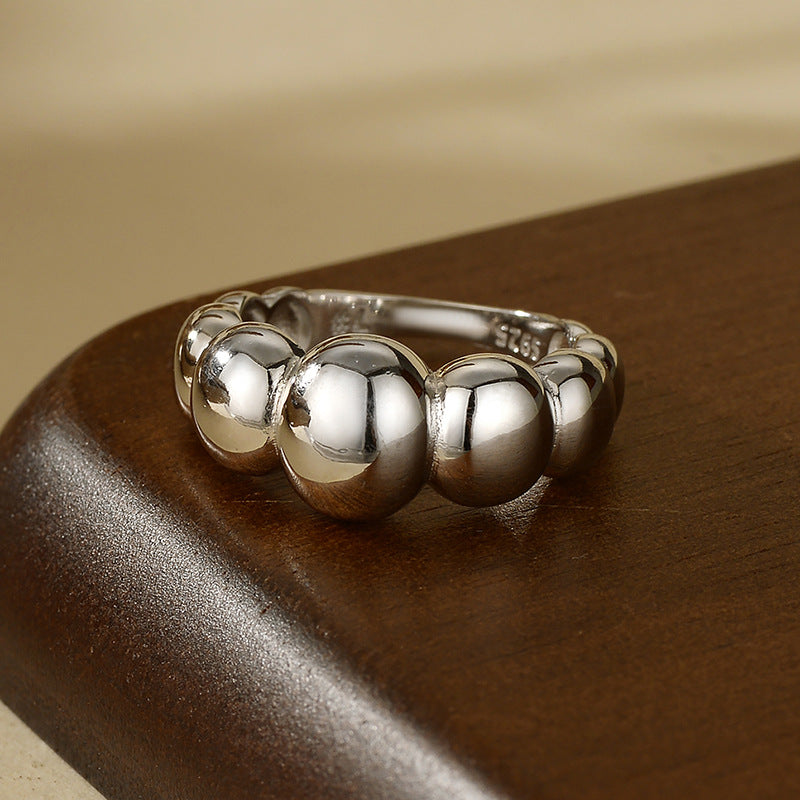 “Flat lay of S925 sterling silver geometric dome ring with mirror polish”